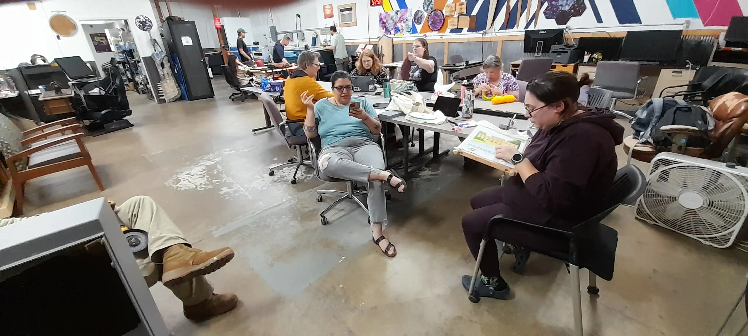 Fiber arts meetup members working together at large tables